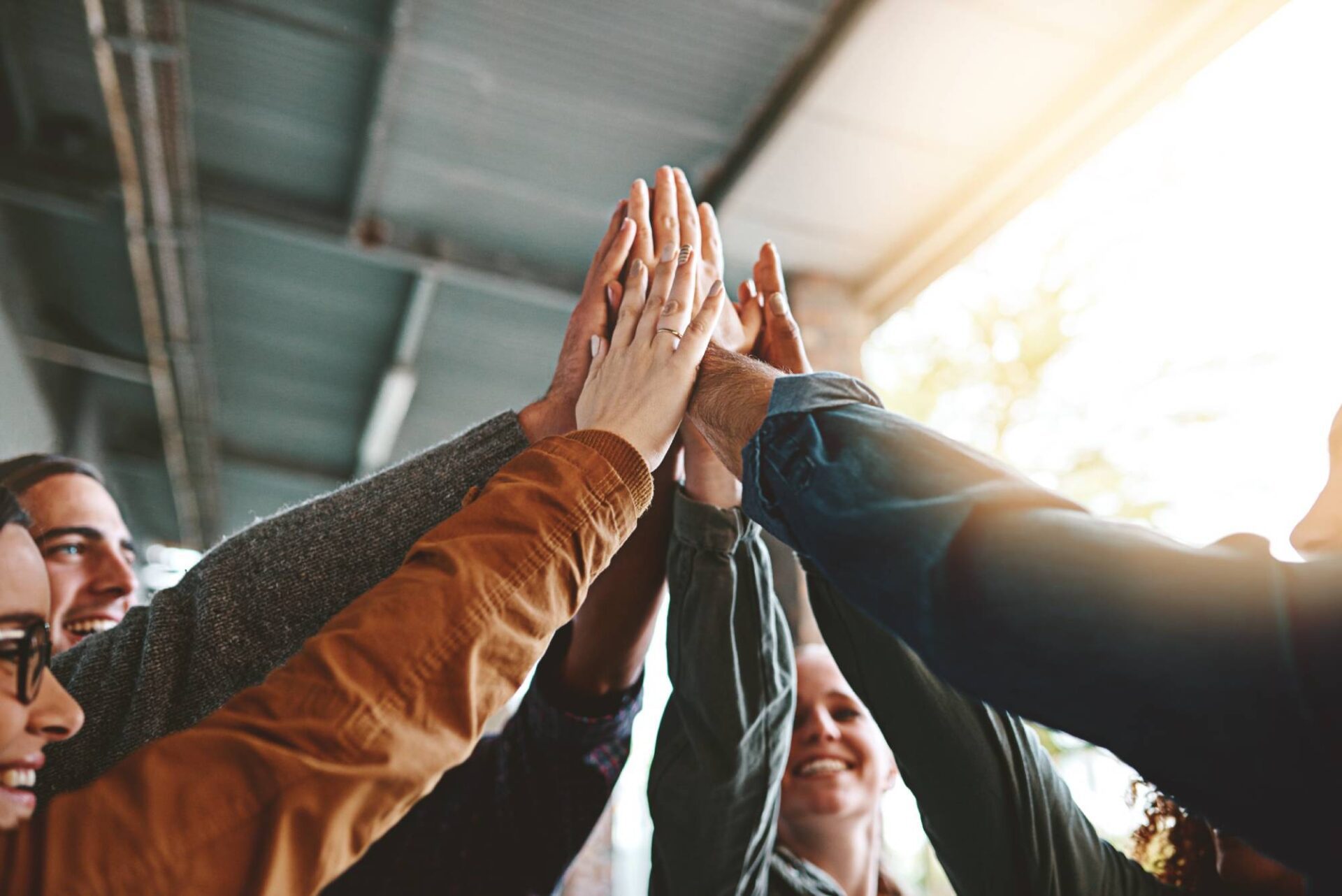 Happy, people and high five for teamwork outdoor with education success, learning achievement and studying. Collaboration, students and celebration for knowledge goals, partnership and university